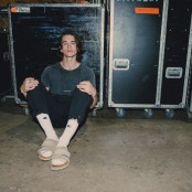 Chance Pena sat in front of some flight cases